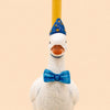 The Blue Goose Cake Topper - Final Sale is a handcrafted birthday decoration featuring a white goose figurine dressed in a blue bow tie and a blue party hat adorned with yellow dots, set against a beige background.
