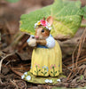 The Wee Forest Folk Tiny Collectible - Bluebird of Happiness (Not a Toy) features a handmade mouse in a yellow floral dress with a flower crown, gently holding a bird, standing on soil with green leaves and small painted flowers.
