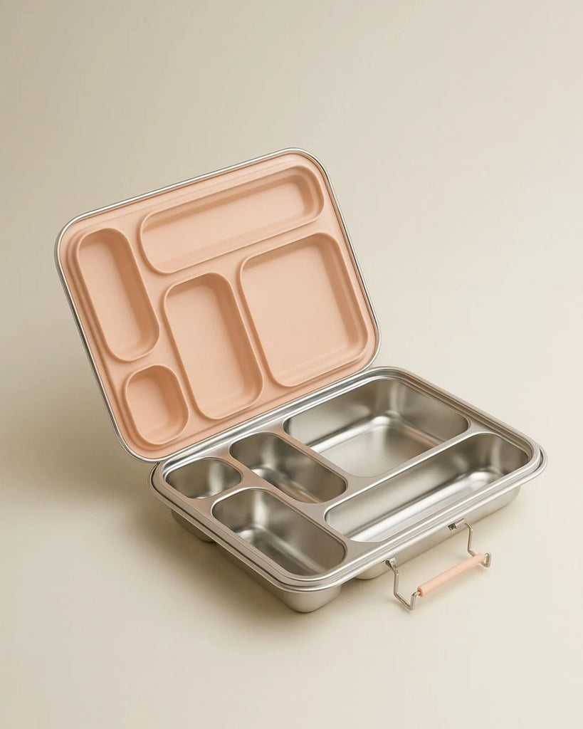 The Haps Nordic - Stainless Steel Lunch Box - Multi-Compartment (Blush) features several compartments and a light pink blush lid, shown open on a neutral background—making it the ideal meal prep container for organized lunches.