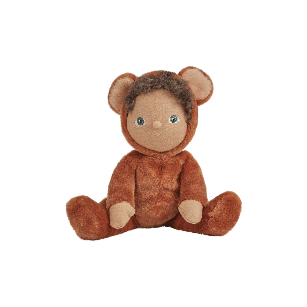 A plush toy resembling a teddy bear with human-like features, such as a distinct nose and ears, depicted sitting against a black background with white horizontal stripes. This particular model is known as Olli Ella | Dinky Dinkums Forest Friends - Bobby Bear.