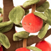 The Bukowski Apple Tree features a plush red apple with a smiling face attached to a soft fabric branch with green leaves—crafted from fuzzy material for safe, imaginative play.