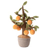 The Bukowski - Orange Tree is a plush toy shaped like an orange tree, featuring smiling fruit and green leaves in soft fabric, sitting in a gray felt pot—ideal for cuddly play and imagination.