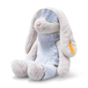 The 12-inch Steiff Hoppie Rabbit in Ski Outfit sits upright, featuring light gray fur, floppy ears, a soft blue belly, iridescent glasses, and a yellow tag on its left ear.