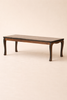 A low, dark wooden table with four curved legs from the Maileg Grand Dining Room Set, perfectly sized for a Maileg Mouse Size dollhouse, set against a plain, light-colored background.