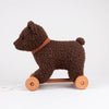 Pull-Along Raoul by Egmont Toys is a plush brown bear toy with a red collar, mounted on a wooden base with four wheels and a pull string—making it the perfect companion for little adventurers, all set against a plain white background.