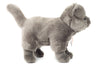 A side profile of the Teddy Hermann Gray Standing Cat Stuffed Animal shows it standing on all four legs. This lifelike plush toy features a fluffy tail, round ears, and detailed stitching representing the eyes, nose, and mouth. The soft and smooth fur gives it an incredibly realistic appearance.