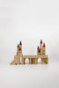 The Great Kingdom Building Set is a wooden toy castle that showcases smooth edges, multiple towers, arched doorways, and intricately designed red and brown conical roofs. Each piece is crafted using non-toxic paint and displayed against a plain white background.