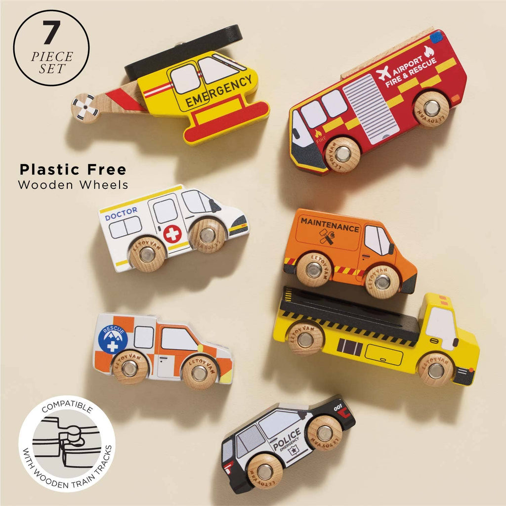 The Emergency Helicopter & Rescue Cars set includes seven wooden emergency vehicles—helicopter, fire truck, ambulance, and more—displayed on a beige background. These plastic-free toys are perfect for imaginative play with sturdy wooden wheels.