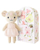 Cuddle + Kind Tiny Emma the Mouse is a hand-knit doll in a pale pink dress with a floral headband. Handmade in Peru, she comes with a floral-patterned box featuring her illustration and "emma the mouse" on the front.