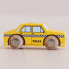 A yellow wooden No. 39 GT245 Trixie taxi toy, made in England, featuring classic black and white checkered detailing and “TAXI” on the side—shown in profile on a light background—perfect for imaginative play inspired by an iconic New York cab.