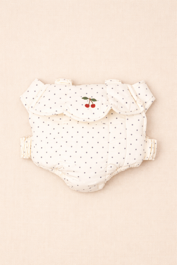 A cloth diaper and the Konges Sloejd Doll Carrier - Estate Dot rest neatly on a white surface.