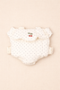 A cloth diaper and the Konges Sloejd Doll Carrier - Estate Dot rest neatly on a white surface.