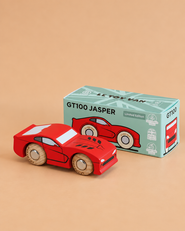 A red wooden sports car, crafted from sustainable wood, is displayed next to its box—which reads “No. 18 GT100 Jasper | Made in England” and features an illustration of the car on a green background. This classic collectible combines timeless style with eco-friendly materials for the ultimate performance motoring display piece.