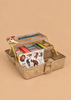 The Konges Sloejd Creative Art Caddy - Tiger, an open glittery gold toolbox filled with kids’ art supplies—colored markers, crayons, scissors, a ruler, glue, and a sheet of animal stickers—invites imaginative play on a beige background.