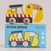A yellow construction toy excavator with red-and-white stripes sits on a blue box labeled “No. 37 GT210 Eddie | Made in England.” The box features an illustration of the same building site toy, along with “Limited Edition” and age 2+ warnings.