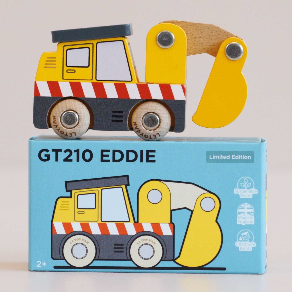 A yellow construction toy excavator with red-and-white stripes sits on a blue box labeled “No. 37 GT210 Eddie | Made in England.” The box features an illustration of the same building site toy, along with “Limited Edition” and age 2+ warnings.