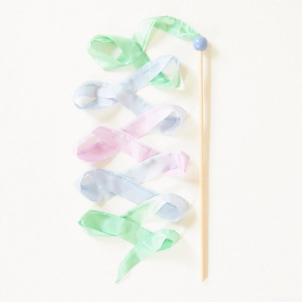 A Sarah's Silk Robin's Egg Blue Streamer Wand, adorned with Rainbow Streamers in soft pastel shades of pink, blue, and green, arranged in a flowing, whimsical pattern on a light background.