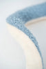 Close-up of a soft, two-toned Light Blue Stingray with a high texture in pale blue and off-white, focusing on the plush surface and curved edge of a plush toy.