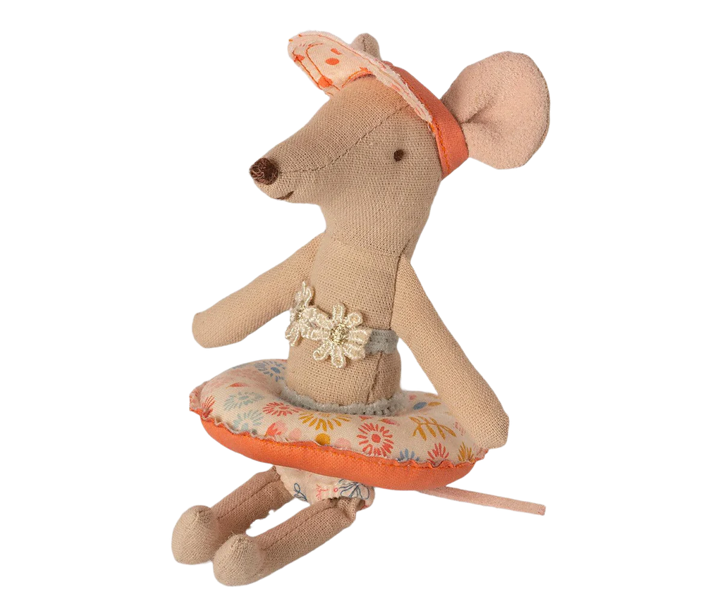 The Maileg Tube, Small Mouse - Flower is a delightful little mice toy dressed as a ballerina. It features a floral-patterned tutu with orange trim and a flower embellishment on its chest. With large ears, a headband, and shades of beige and orange, this charming toy invites endless imaginative play.