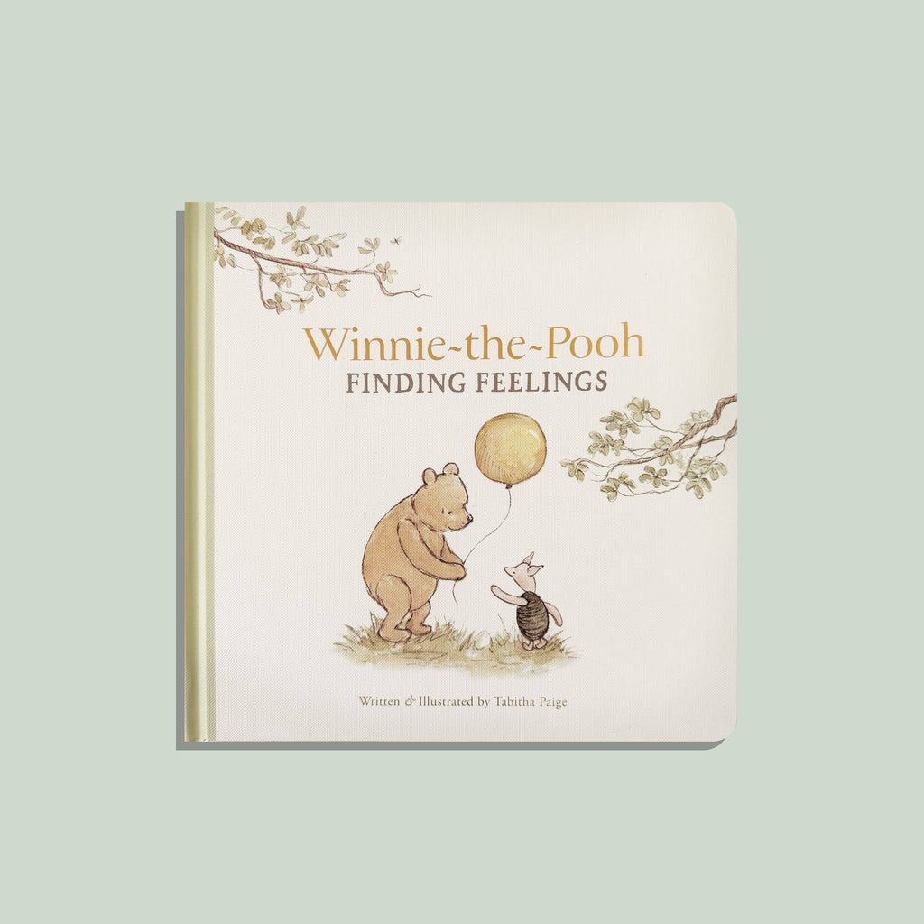 The cover of Winnie-the-Pooh: Finding Feelings shows Pooh with a yellow balloon and Piglet gazing up at him, introducing emotions for toddlers on a pale green background.