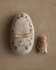 The Coral & Tusk Pocket Easter Egg features a plush embroidered egg with a white rabbit and flowers, plus a smaller bird-shaped toy with orange and brown details—charming accents for any Easter basket.