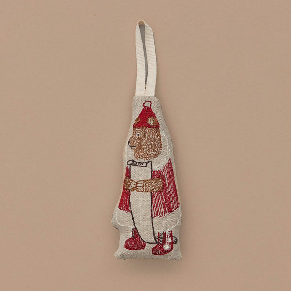 Featuring the North Pole Bear Ornament, this delightful decoration showcases Santa Bear in a red hat and coat with white trim, holding a long scroll. Set against a simple beige background, it comes with a loop for effortless hanging on your Christmas tree.