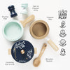 Pots & Pans Kitchen Accessories set featuring a frying pan, copper pan, lidded pot, wooden spoon, and salt and pepper mills, with labels and icons highlighting developmental skills for pretend play.