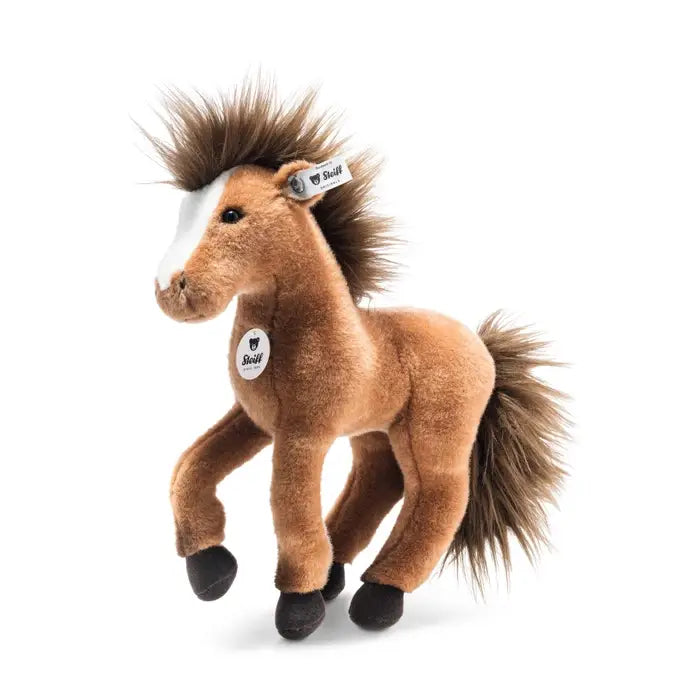 A Steiff Chayenne Horse plush toy in brown with a white blaze on its face, standing with one front leg raised in a dressage horse pose.
