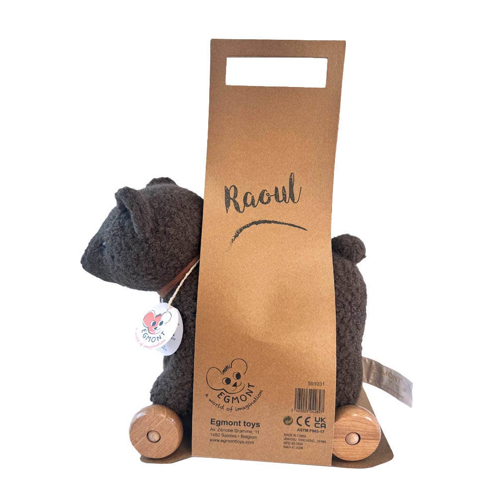 Pull-Along Raoul from Egmont Toys is a woolen cat-shaped pull-along toy with wooden wheels, beautifully packaged in a cardboard holder labeled "Raoul." This charming plush companion features a heart-shaped tag hanging from the cat’s collar, making it an adorable choice for little ones.
