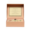 An open peach-colored box holds the Memory Game - Festival of Flowers, featuring illustrated watercolor flower cards. Game instructions are printed on the inside lid, and three floral cards can be seen inside the box.