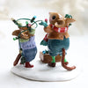 The Wee Forest Folk Tiny Collectible - Merry & Bright features two hand-sculpted mice in winter clothes, one tangled in Christmas lights while the other helps, both on a snowy base with an ornament box—perfect festive miniatures for the season.