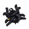 Steiff Cobweb the Spooky Spider is a fluffy black Halloween plush with eight legs, red eyes, and a soft, shaggy texture. Part of the Halloween Friends collection, it has a yellow tag on one leg and is shown on a white background.