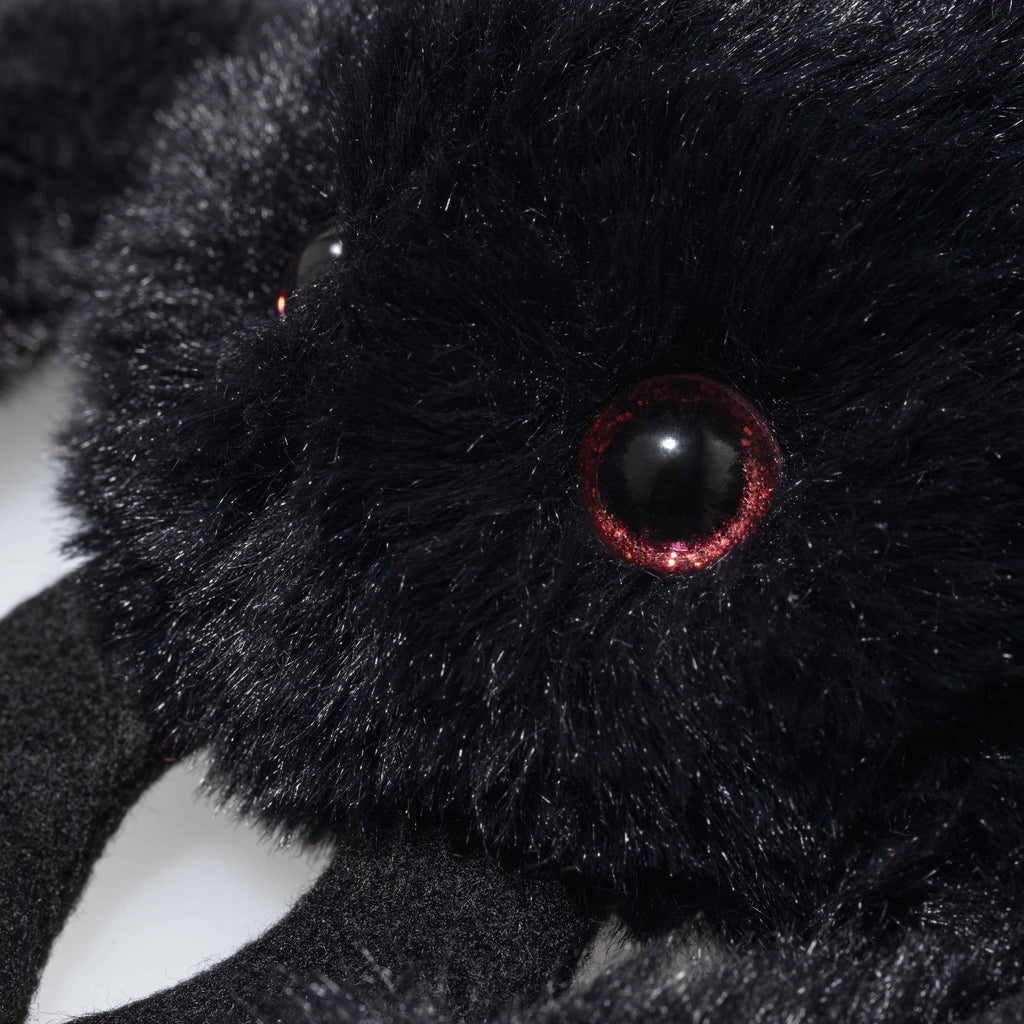 Close-up of Steiff Cobweb the Spooky Spider plush toy, featuring shiny red-rimmed eyes and soft, fluffy fur—perfect for adding to your Halloween Friends collection.