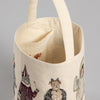 Cloth Trick or Treat Small Bucket with illustrated animals in human attire, showing a detailed close-up of the bucket's straps and open top, adorned with an embroidered tissue cover.