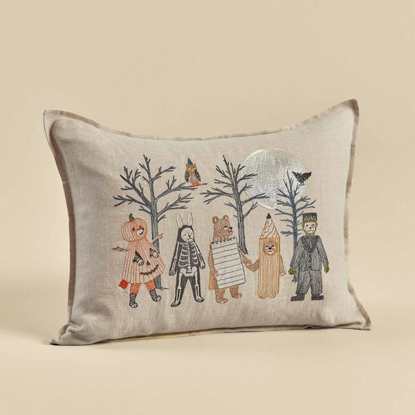 Decorative Full Moon Masquerade Pillow featuring a whimsical woodland scene with a bear, trees, birds, and three characters dressed in animal costumes including a Wizard Puppy and a Witchy Fox on a beige background.