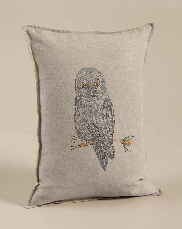 A Coral & Tusk Great Grey Owl Pillow featuring a detailed embroidery of a Great Grey Owl perched on a branch against a light beige background.