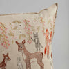 Coral & Tusk Spring Blossoms Pillow featuring embroidered forest animals such as deer, rabbits, and foxes on a linen fabric background.