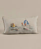 A Coral & Tusk Swimmers Pocket Pillow featuring an embroidered design of cats on a sailboat and floating on inner tubes, set against a neutral beige background, ideal for ocean-themed decor.