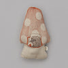 A Coral & Tusk Pocket Mushroom artwork depicting a plush hedgehog, with a gray base and an orange cap adorned with white spots. The cap features detailed embroidery of a gnome reading inside, set against a neutral background.