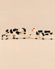 Four Holztiger Handmade Wooden Black & White Cow Family Set figurines of varying sizes standing on a light surface, ideal for imaginative play.