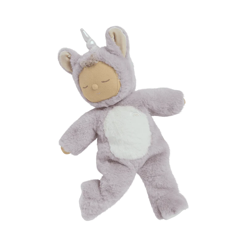 The Olli Ella Cozy Dinkum Doll Unicorn - Sweetpea features soft lavender fur, a white belly, and a shimmering horn with a serene, closed-eye face, posed on a plain background, appearing irresistibly cuddly.