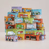 A pyramid stack of colorful toy vehicle boxes, including the No. 38 GT220 Vince (made in England), each labeled with a name and illustration of a car, bus, or train—perfect for imaginative play—is set on a light surface against a plain background.
