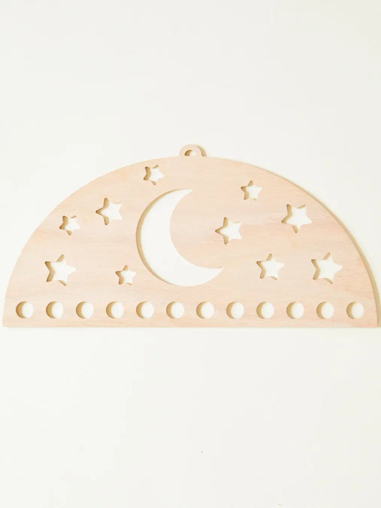 A Red Oak MDF Sarah's Silk Large Star Playsilk Display with a crescent moon and stars cut out, and a series of circular holes along the bottom edge, against a plain light background.