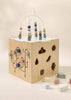 The Wooden Activity Cube is a pastel toddler toy with a bead maze, shape sorter, and soft blocks—ideal for fine motor skill development and stylish play.