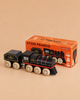 A black and red steam train wooden toy, named “No. 49 GT295 Francis” and made in England, is displayed in front of its orange box packaging, which showcases an image and details of this limited edition model—perfect for sparking imaginative play and capturing the timeless charm of classic rail travel.