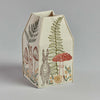 A Coral & Tusk Mushrooms and Ferns tissue box cover featuring an embroidered design of a rabbit, various mushrooms, and foliage on a neutral backdrop.