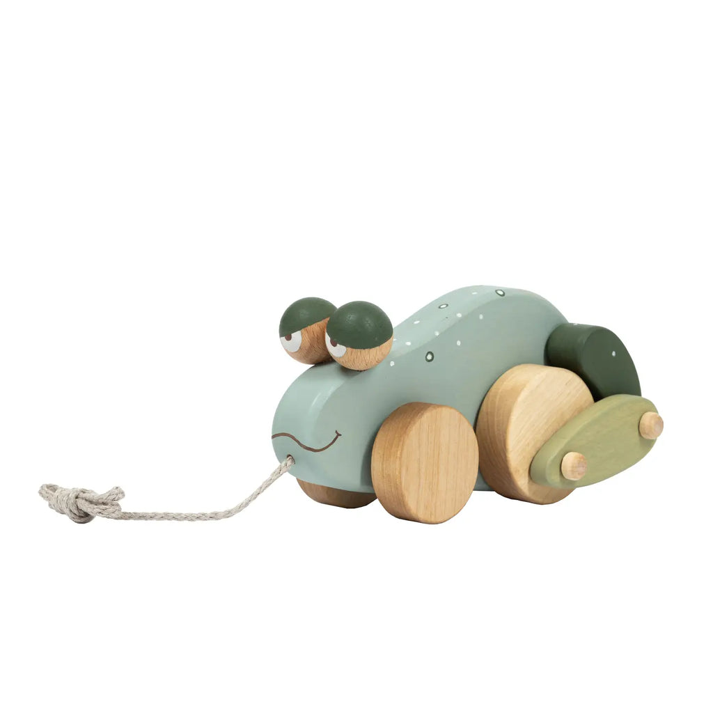 A sustainable toy resembling a stylized green hippopotamus with round wooden wheels, small wooden ears, and a dotted pattern on its back, featuring a pull string. 
Product Name: Handmade Pull Along Frog Toy