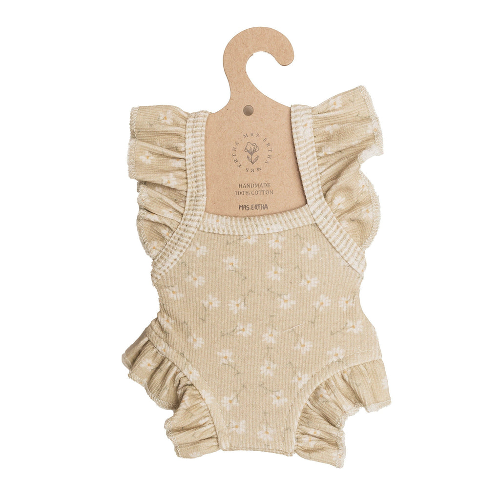 Mrs. Ertha Doll Clothes - 13″-14″ Little Daisys Frilled Bodysuit: A beige romper adorned with white daisy patterns and ruffled sleeves, displayed on a brown hanger. This handmade, 100% cotton bodysuit is perfectly sized for Minikane dolls.