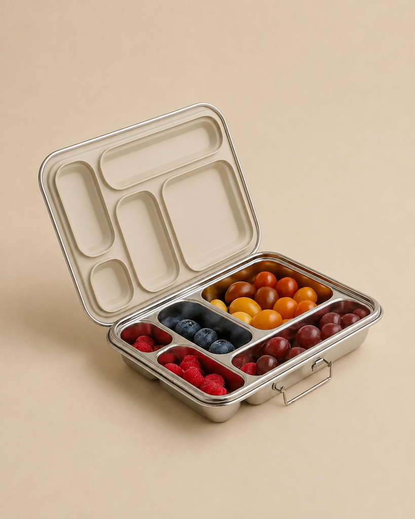 The Haps Nordic - Stainless Steel Lunch Box - Multi-Compartment (Steel) sits open on a beige background, with its five compartments filled with raspberries, blueberries, yellow cherry tomatoes, red cherry tomatoes, and red grapes—perfect as a meal prep container.