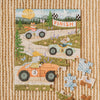 A nearly completed Little Racers 40 Piece Mini children’s jigsaw puzzle on a woven rug shows cartoon animals in cars racing toward a finish line. Three pieces are missing, and some loose pieces from the Little Racers puzzle lie nearby.